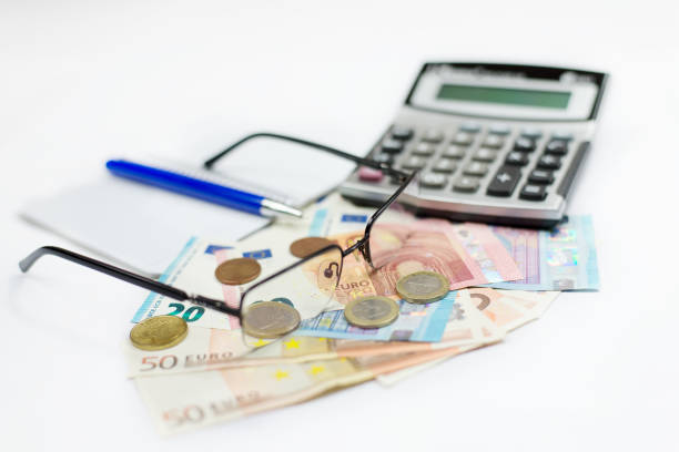 Euro money, glasses and calculator. Selected focus. stock photo