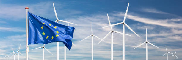 European Union flag in front of a large windpark with wind turbines stock photo