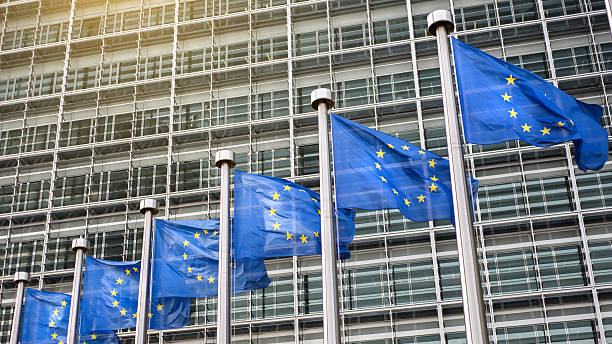 European Union flags in front of the Berlaymont stock photo