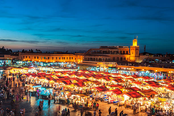 Evening Djemaa El Fna Square with Koutoubia Mosque, Marrakech, Morocco Famous Djemaa El Fna Square in early evening light, Marrakech, Morocco with the Koutoubia Mosque, Northern Africa.Nikon D3x koutoubia mosque stock pictures, royalty-free photos & images