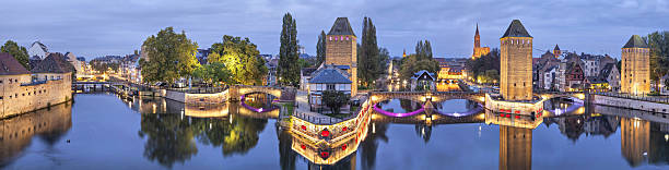 Evening panorama of Pont Couverts in Strasbourg Evening panorama of Pont Couverts made from Vauban dam in Strasbourg, France petite france strasbourg stock pictures, royalty-free photos & images