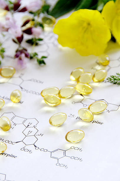 evening primrose and herbs with capsules stock photo