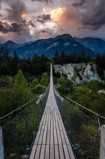 Evening shot of a wooden hanging bridge near the towns Susten and Leuk in Canton Wallis Evening shot of a wooden hanging bridge near the towns Susten and Leuk in Canton Wallis valais canton stock pictures, royalty-free photos & images