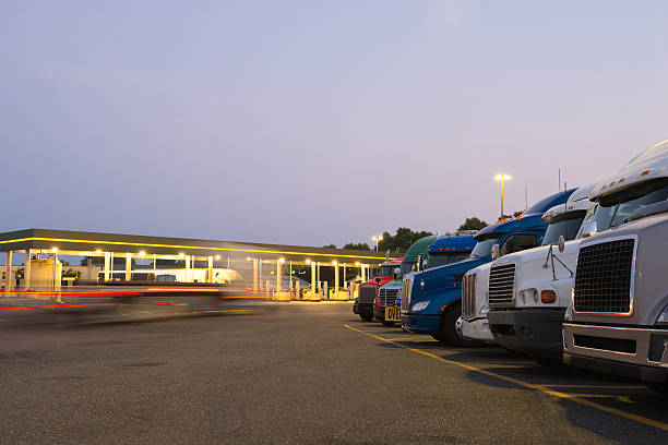 Evening truck stop lights of number of trucks in parking stock photo