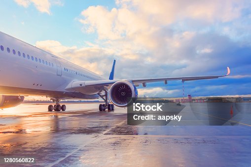 istock Evening view of a passenger plane wing with engine. 1280560822