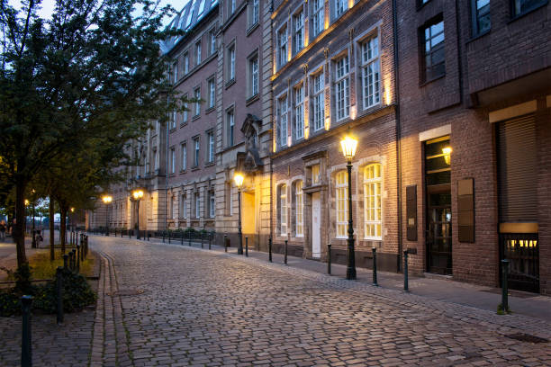 Evening view of old, historical buildings and cobblestone street in Altstadt Dusseldorf. Evening view of old, historical buildings and cobblestone street in Altstadt Dusseldorf. historic district stock pictures, royalty-free photos & images