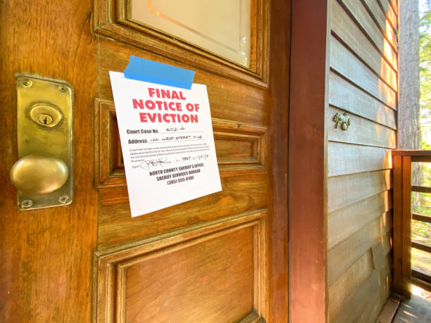 Eviction notice on door of house Eviction notice on door of house with brass door knob. Fictitious address, ID, signature and 555 phone number for fictional usage. foreclosure stock pictures, royalty-free photos & images