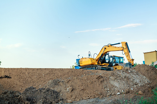 Excavator on the construction of a road embankment