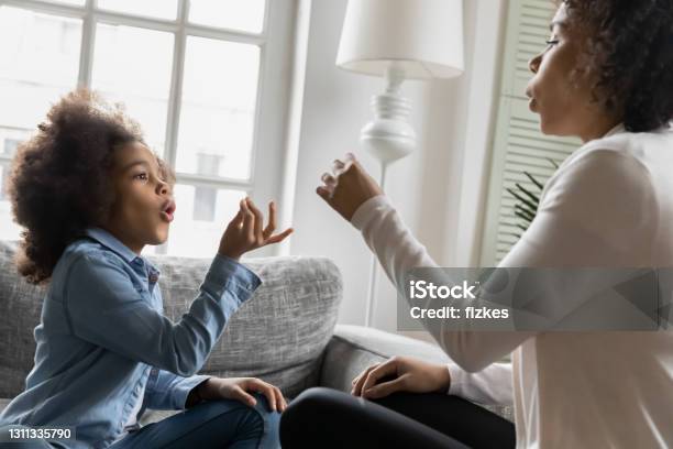 Excited African American kid talking to mom nonverbal