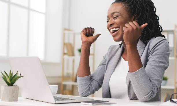 Excited Afro Businesswoman Celebrating Success At Work Business Success. African American Businesswoman Celebrating Victory At Work. Free Space excitement stock pictures, royalty-free photos & images