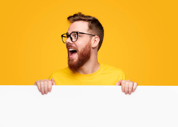 Excited bearded man with empty banner stock photo