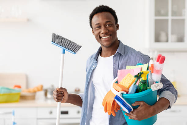 excited black guy ready for cleaning apartment - städning man bildbanksfoton och bilder