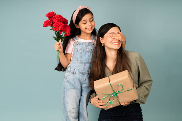 Excited girl bringing a Mother's day gift stock photo