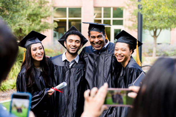 Excited group of graduates pose for photo A happy group of diverse friends smile while posing for a photo after their college graduation. best schools stock pictures, royalty-free photos & images