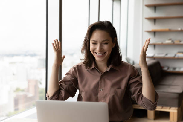 Excited happy business woman celebrating win, success, achieve stock photo