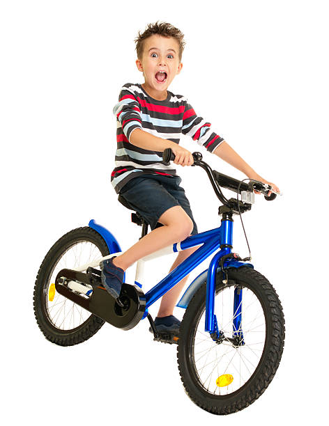 Excited little boy on bike stock photo
