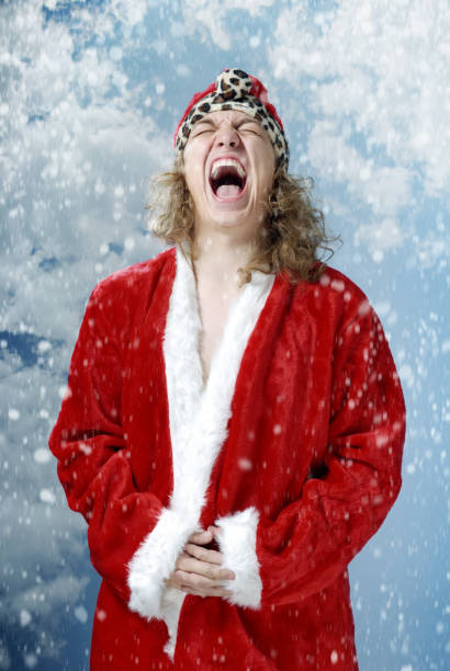 Excited screaming Santa outdoors enjoys snowfall stock photo