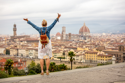 Excited Woman With Hand Raised Looking At Florence City