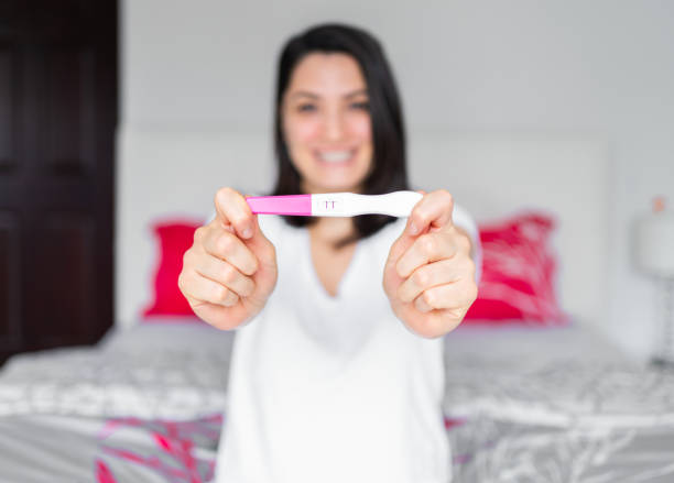 Excited woman with positive pregnancy test. Celebrating positive pregnancy test result. Yes, I am pregnant Excited woman with positive pregnancy test. Celebrating positive pregnancy test result. Yes, I am pregnant positive pregnancy test stock pictures, royalty-free photos & images