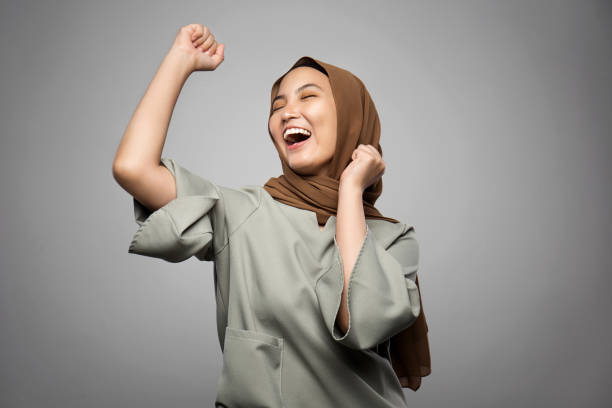 Excited young Muslim woman in white background Excited young Muslim woman in white background hijab stock pictures, royalty-free photos & images