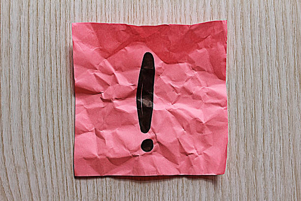 Exclamation mark on paper stock photo