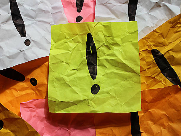 Exclamation mark on paper stock photo