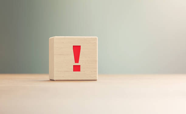 Exclamation Point Written Wood Block Sitting on Wood Surface in Front a Defocused Background Exclamation point written wood block sitting on wood surface in front of a defocused background. Horizontal composition with copy space. danger photos stock pictures, royalty-free photos & images