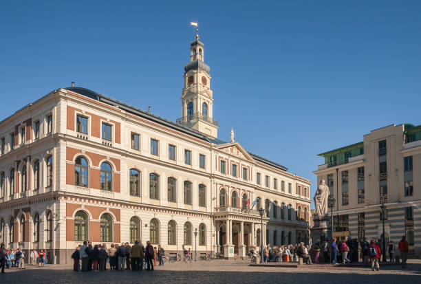 Excursion groups near the town hall in Riga Riga, Latvia - September 01, 2014: Excursion groups near the town hall in Riga. Many tourists visit the old city of Riga for sightseeing unesco organised group stock pictures, royalty-free photos & images