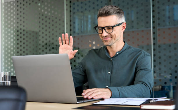 Executive businessman using laptop having video conference call virtual meeting. stock photo
