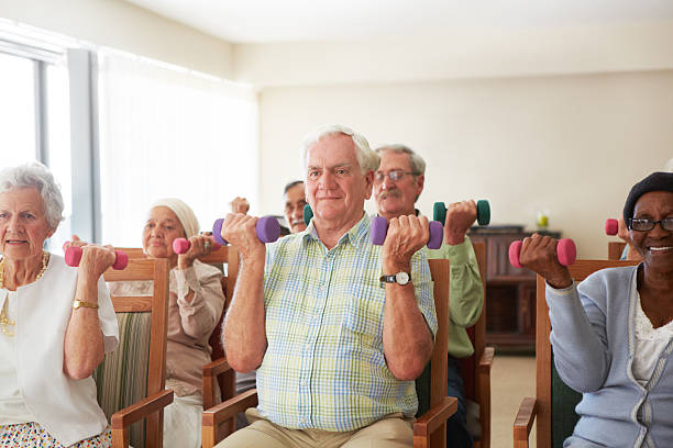Daily light weight lifting exercise routine for the elderly at an old...
