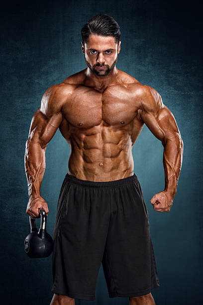 Exercise With Kettle Bell Male Athlete exercise with Kettle Bell. male bodybuilders stock pictures, royalty-free photos & images