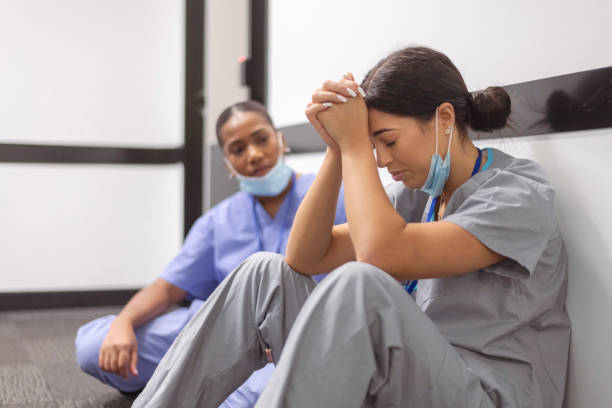 Exhausted and stressed nurses need a break from their shift stock photo