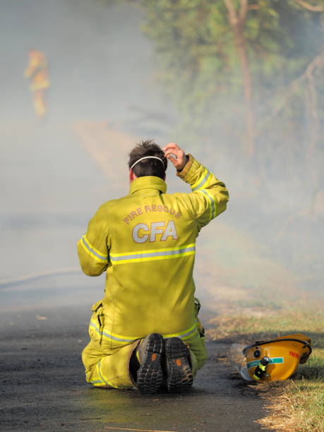 Exhausted Fire fighter at a bush fire in an suburban area of Knox City in Melbourne east. stock photo