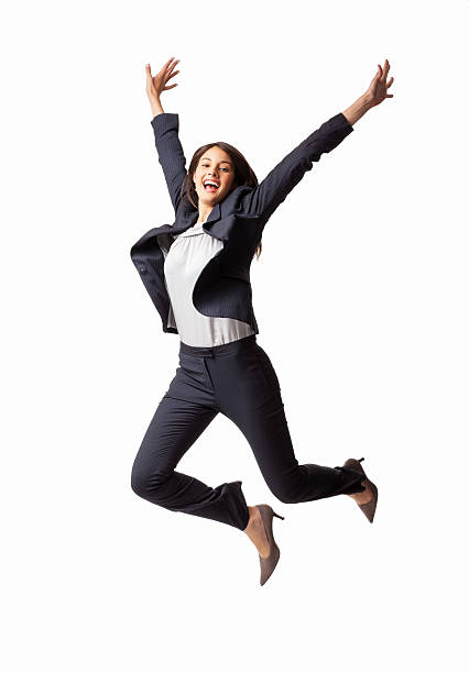 Exhilarated Businesswoman - Isolated Full length of an exhilarated young businesswoman jumping in mid-air. Vertical shot. Isolated on white. exhilaration stock pictures, royalty-free photos & images