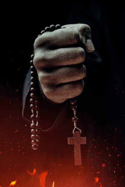 Exorcist Exorcist holding crucifix above fire evil photos stock pictures, royalty-free photos & images