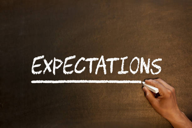 Expectations Word On Blackboard Expectations handwriting with chalk on blackboard. Business concept. anticipation stock pictures, royalty-free photos & images