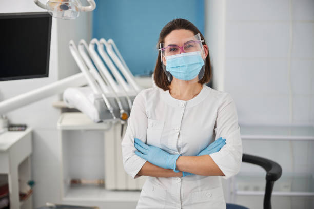 Experienced woman dentist standing in the middle of her office stock photo