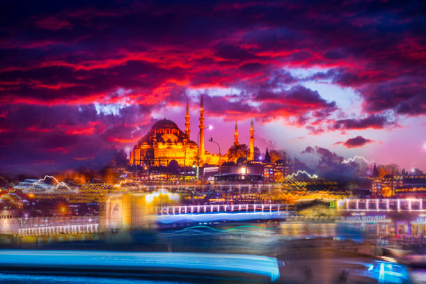 Experimental Surrealist abstraction.Galata Bridge and the lines of the ferry light with a long exposure .Suleymaniye mosque in the background at the sunset,Istanbul,Turkey stock photo