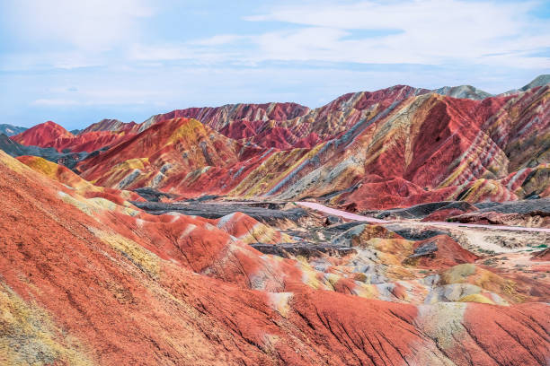 Exploring China's rainbow mountain in summer Exploring China's rainbow mountain in summer danxia landform stock pictures, royalty-free photos & images