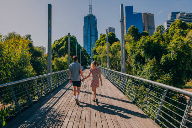 Exploring Melbourne, Australia Young couple walking through Birrarung Marr in Melbourne, Australia. melbourne street stock pictures, royalty-free photos & images