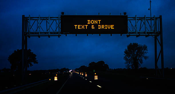 Expressway Night Construction Zone DON'T TEXT AND DRIVE Road Sign stock photo