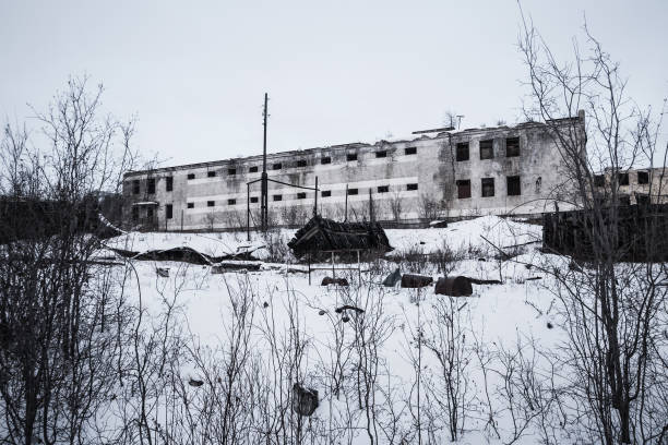 Exterior of old decayed abandoned prison in Kolyma in evening light stock photo