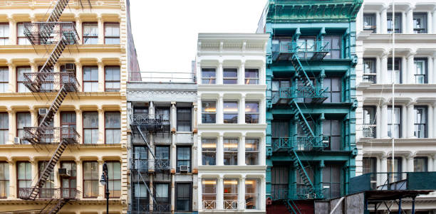 Exterior view of a block of colorful old historic buildings along Greene Street in the SoHo neighborhood in Manhattan, New York City stock photo