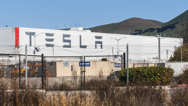 Exterior view of Tesla Factory located in East San Francisco bay area Feb 17, 2020 Fremont / CA / USA - Exterior view of Tesla Factory located in East San Francisco bay area; Large Tesla logo displayed on one of the buildings visible behind a fence tesla motors stock pictures, royalty-free photos & images