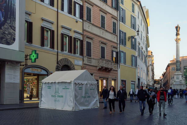 External day view of Italian pharmaceutical shop with illuminated green display also conducting quick swabs. stock photo