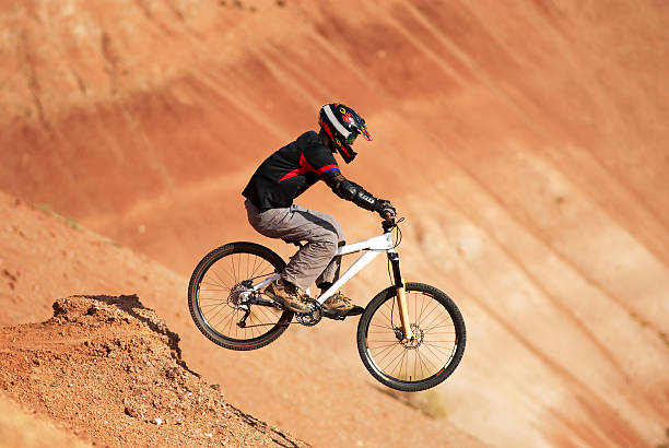 Extreme biker in red canyon stock photo