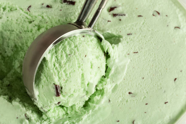 Extreme close up of green ice cream being scooped up stock photo