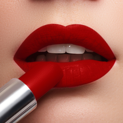 Extreme Close Up On Model Applying Dark Red Lipstick Makeup Stock Photo - Download Image Now - iStock