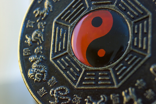 Extreme closeup macro photography of a Chinese Bagua object showing ying yang theory. Art and culture of China concept.