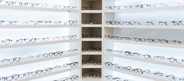 Eye glasses in ophthalmology clinic Big choice of eyeglasses on shelves in ophthalmology clinic. Modern light ophthalmology clinic. optical instrument stock pictures, royalty-free photos & images